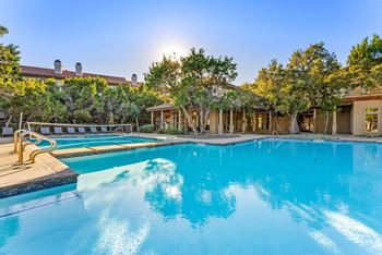 A large swimming pool with a sunny sky in the background. at Bridge at Heritage Woods, Austin, TX